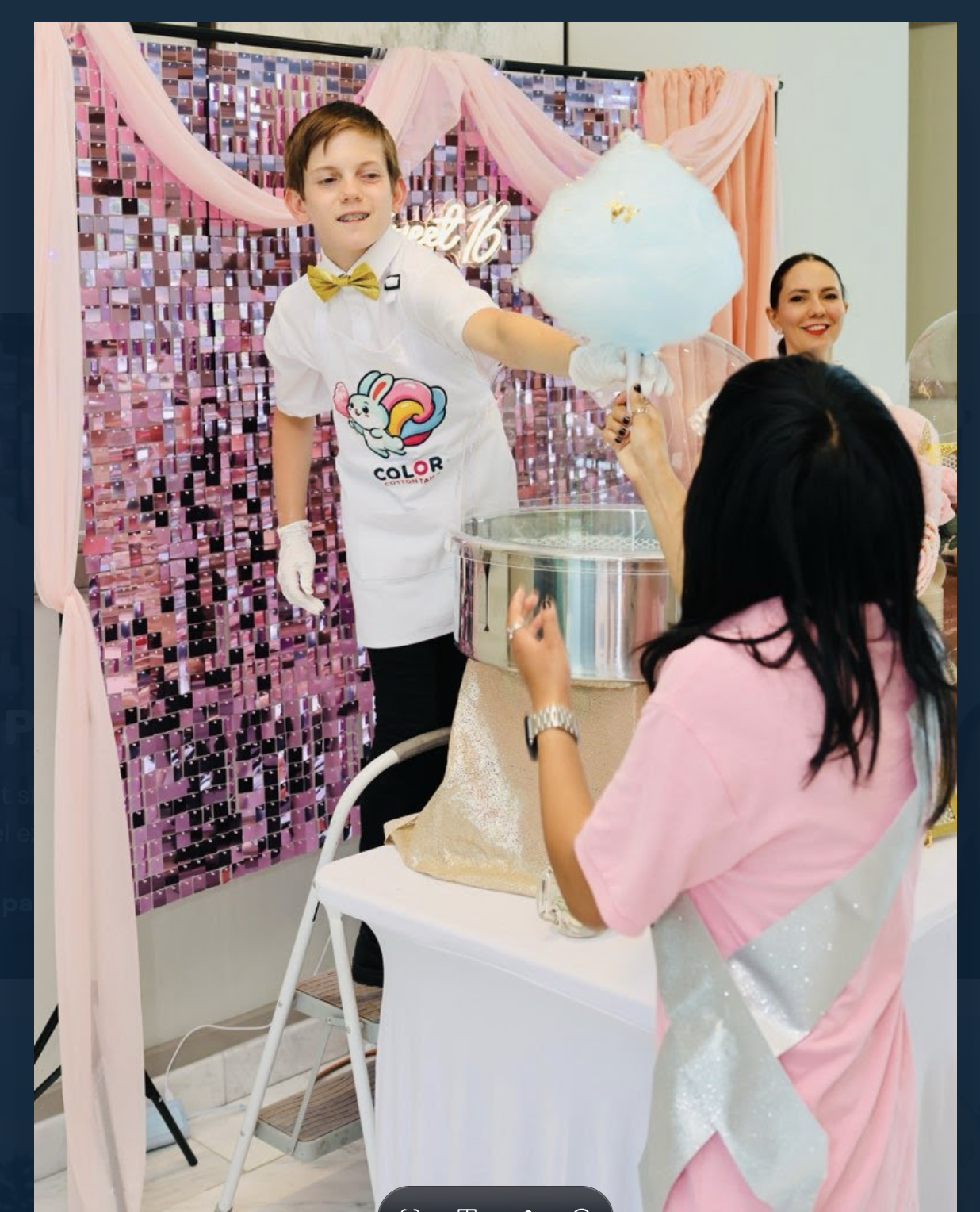 Liam serving blue cotton candy at a Sweet 16 celebration, wearing his Color Cotton Tails apron and gold bow tie