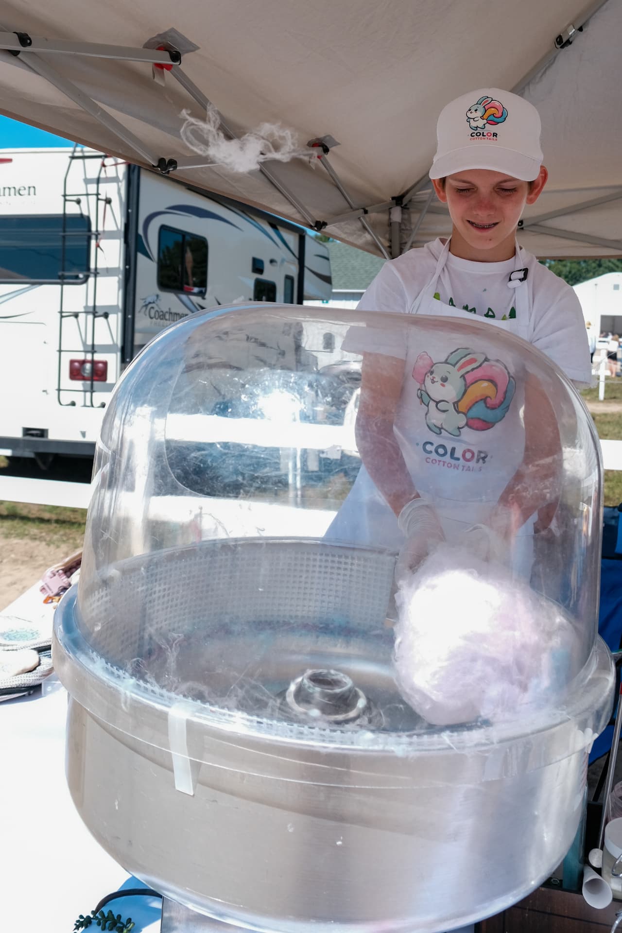 Liam spinning pastel cotton candy at an outdoor event
