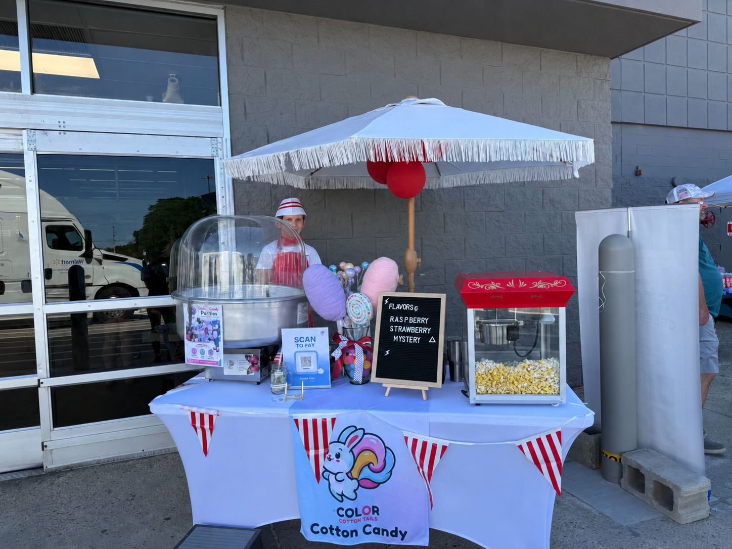 Liam staffing the Color Cotton Tails cotton candy and fresh popcorn cart setup